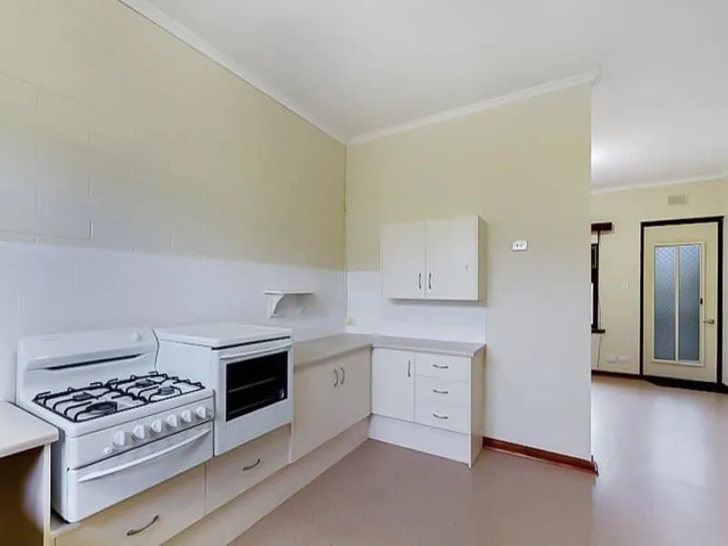 Kitchen with gas stove, separate oven, corner bench and overhead cupboards